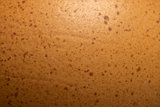 Macro shot of speckled brown chicken eggshell texture,An extreme close-up macro photograph showing the detailed texture and brown speckled patterns on the surface of a chicken eggshell.