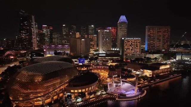 Singapore Marina Bay at night with downtown skyline reflected on water | 4K aerial drone footage