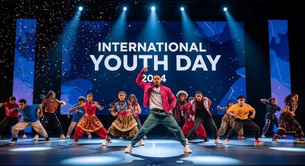 Dynamic dance group performing energetic routine on stage for international youth day event.