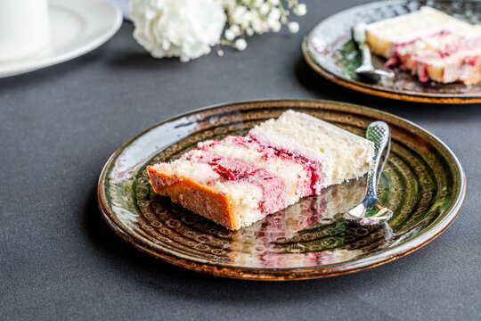 A slice of delicious creamy torte layered with fruit mousse on a plate