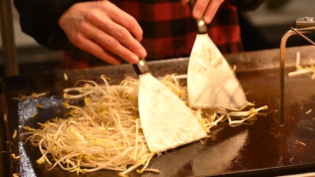 Korean street food preparation at a late-night street stall in Seoul, South Korea.