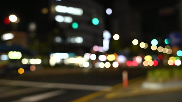 Defocused receding city traffic in the evening. City blur background. Moving bokeh circles of evening traffic in Seoul, South Korea.