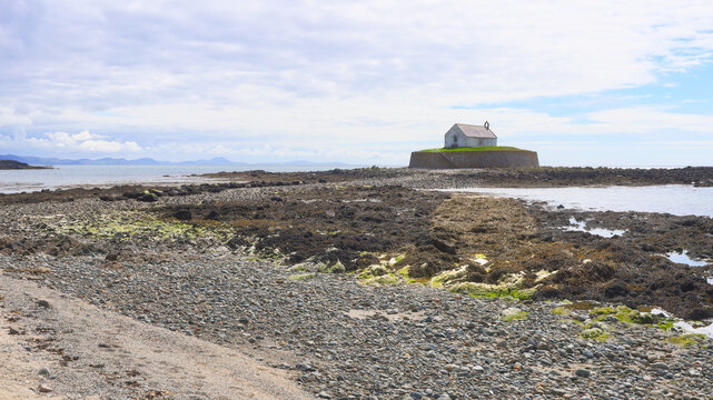 Looking over the beach to St Cwyfan's Church on Anglesey, North Wales. It is also known as Little Church in the Sea and is a grade ll listed building