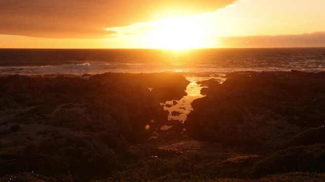 sunset light over rocky coastline of DeKelders, Gansbaai, South Africa
