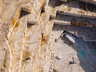 Fototapeta premium Marble quarry terraces excavated and filled with pools aerial view