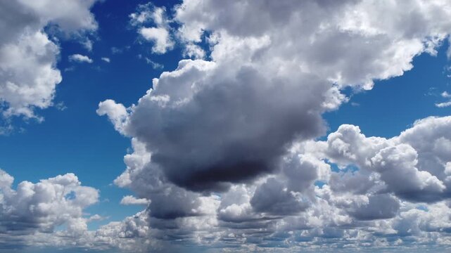 4K aerial drone view of majestic cumulus clouds with deep shadows, cinematic flight through a dramatic sky, beautiful atmospheric weather background, high altitude perspective of white and grey clouds