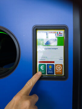 15 May 2026, Aachen, Germany. Close-up of finger selecting deposit payout or donation option on digital reverse vending machine screen