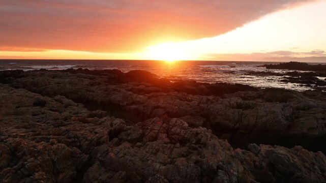 sunset light over rocky coastline of DeKelders, Gansbaai, South Africa