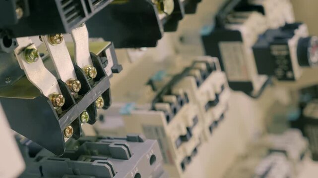A rows of electrical devices in industrial equipment ensure proper operation. Closeup. Macro. Shallow depth of field. Follow focus