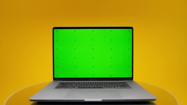 Laptop green screen mockup on yellow background