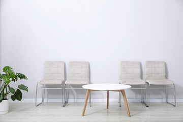 Obraz premium Many stylish light gray chairs and white table indoors