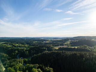 Obraz premium Drone view above forests, meadows and farmland in the Bavarian Forest countryside of Lower Bavaria