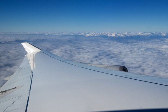 Frankfurt, Germany, 03 November 2017: Airplane wing and engine above the clouds