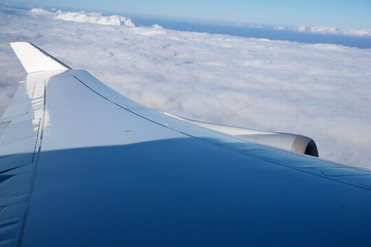 Frankfurt, Germany, 03 November 2017: Airplane wing and engine above the clouds