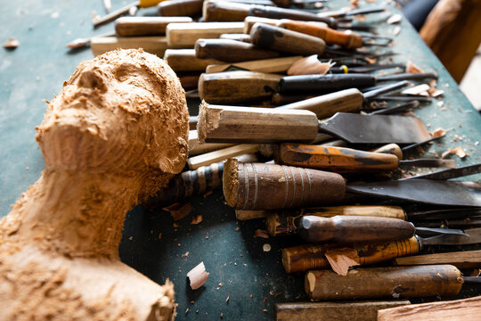 Professional wood carving tools gouges and wooden mallet on an artisan workbench