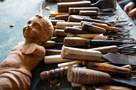 Professional wood carving tools gouges and wooden mallet on an artisan workbench