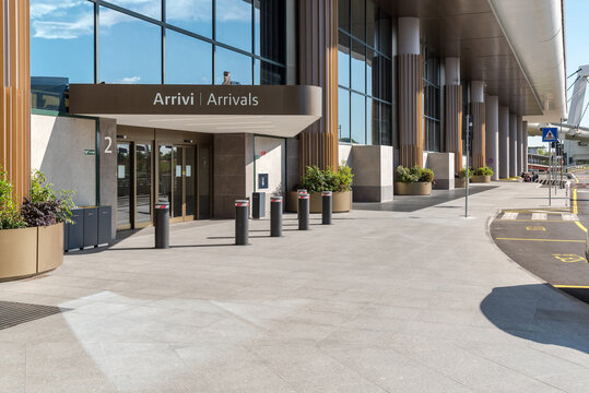 Ferno, Milan-Malpensa, Lombardy, Italy - May 11, 2026: Entrance to the Arrivals area of Terminal 1 at Milan Malpensa Airport, Italy, with the monitored area for temporary vehicle parking.