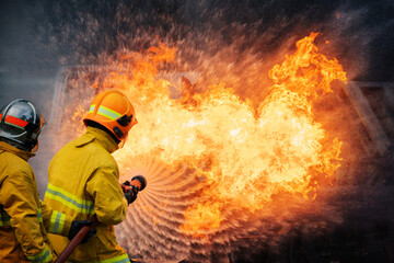 Fototapeta premium Firefighters control a large blaze at an accident scene