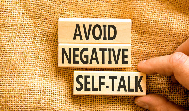 Avoid negative self-talk symbol. Concept words Avoid negative self-talk on beautiful wooden blocks. Beautiful canvas background. Business psychology avoid negative self-talk concept. Copy space.