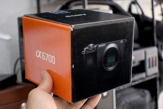 Zapopan Jalisco, Mexico - May15 2026: Hand holding Sony Alpha 6700 camera box, camera unboxing concept
