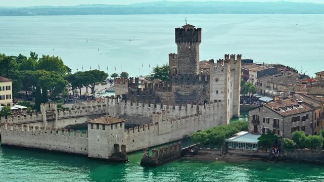 Ancient fortified castle on Lake Garda in Sirmione. Medieval European architecture with towers, battlements and surrounding water