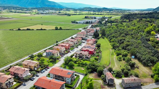 Residential area in Costermano sul Garda next to vineyard fields and rural landscape, aerial view, northern Italy