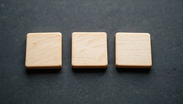 Three blank wooden tiles on dark surface. Ready for game play or craft project. Add letters, words, or designs. Perfect for custom game creation or educational use.