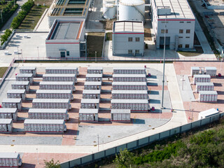 Fototapeta premium Aerial view of large-scale energy storage station with battery container arrays arranged in orderly rows