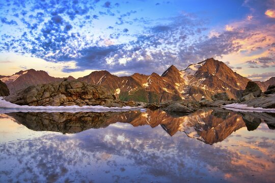 Reflection of the Oberalpstock in a mountain lake, Maderanertal, Canton Uri, Switzerland