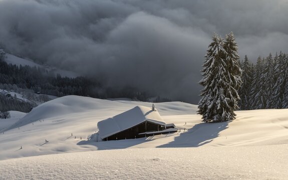 Snow-covered hut in the morning sun, Skiwelt Wilder Kaiser Brixenthal, Hochbrixen, Brixen im Thale, Tyrol, Austria