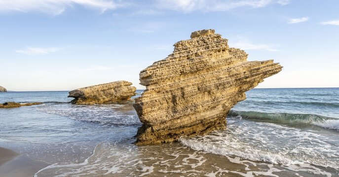 Rocks in the water, waves crashing against rocks, sandy beach with rocky cliffs, Paralia Paradisos, Kos, Dodecanese, Greece