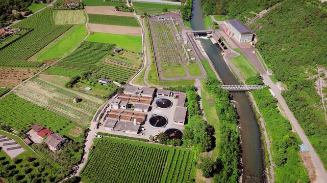Water treatment plant with filtration basins and service buildings, aerial view. Utility infrastructure and water management system