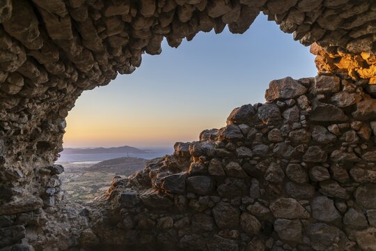 Paleo Pyli castle ruins, view of sea and landscape through hole in castle wall, sunset, os, Dodecanese, Greece