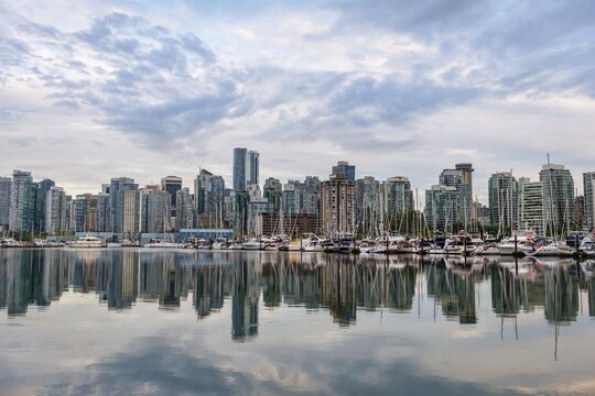Skyscrapers and sailboats in the marina, skyline of Vancouver reflected in the sea, Coal Harbour, Downton Vancouver, British Columbia, Canada