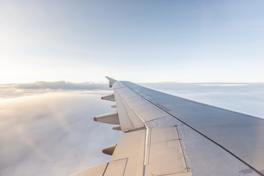 Wing, airplane over cloudy sky, England, Great Britain