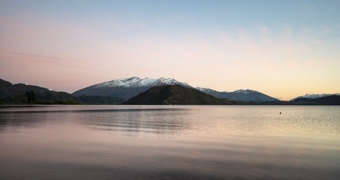 Sunrise, morning mood, Wanaka Lake and snow covered mountains, Glendhu Bay, Otago, South Island