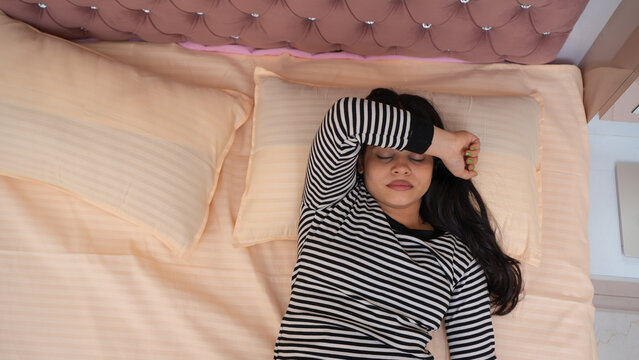 Indian Woman Suffering from Insomnia Lying Awake in Bed, Unable to Sleep at Night, Uncomfort sleeping