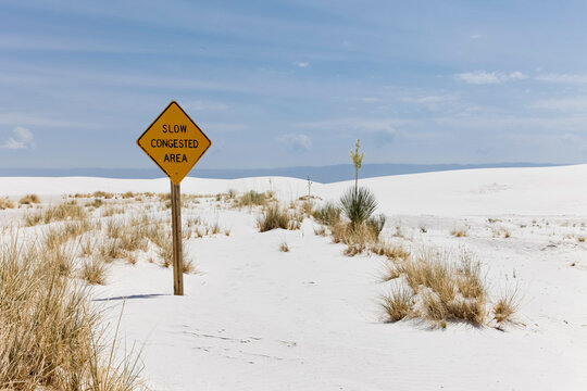 Slow congested area sign in white sand dunes