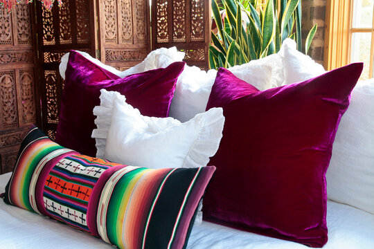 Colorful Southwestern pillows on white bedding