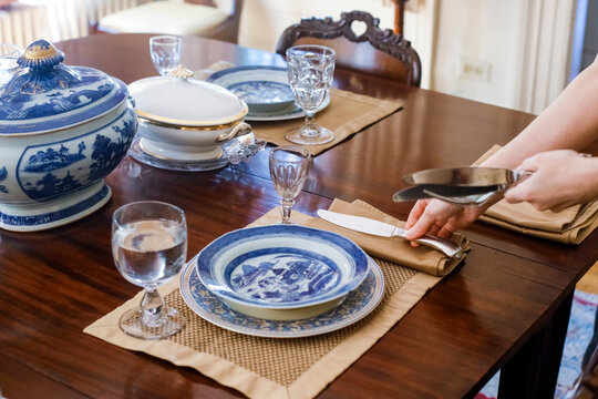 Blue and white table setting with dishes and glassware