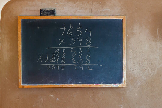 Old chalkboard with handwritten arithmetic