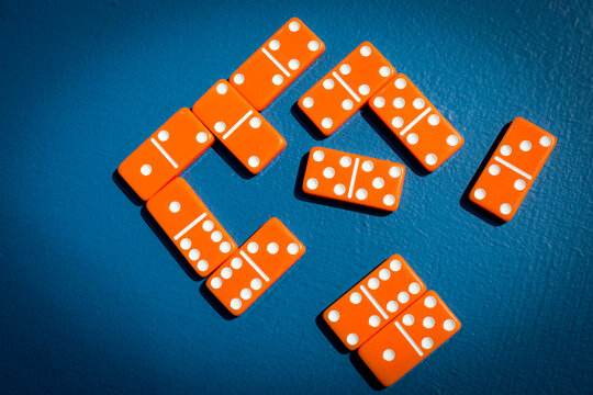 Orange dominoes arranged on a blue surface
