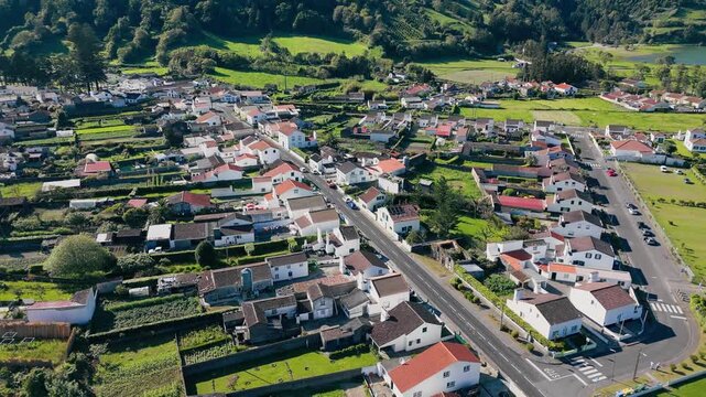 Drone view of Sete Cidades houses and gardens within volcanic caldera, Azores archipelago