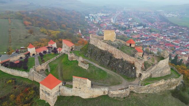 High angle view of the restored Rupea medieval citadel built on a basalt rock in Brasov, Transylvania. Spectacular historic Saxon fortress in a scenic Romanian rural landscape.