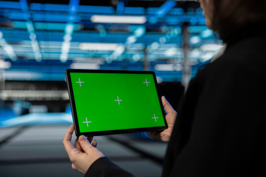 Green screen tablet used by data center technician to configure supercomputers hosting digital services. Closeup of server farm worker using chroma key touchscreen device to repair infrastructure rigs