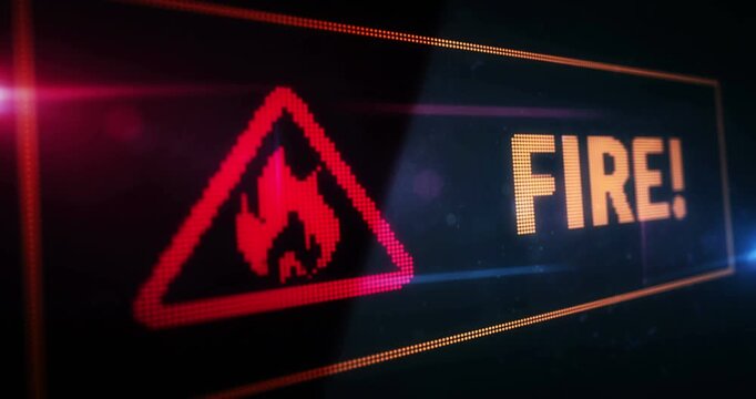 Fire alert symbol light flashing on digital display. Flame danger warning icon on pixel led screen. Close-up abstract concept.