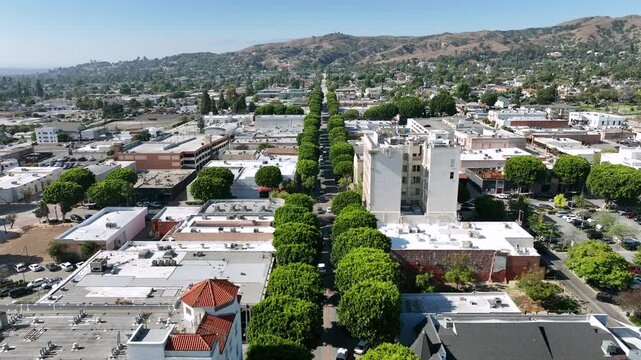 Whittier, California, USA - Cinematic Aerial Drone View Flying Above Greenleaf Promenade in Downtown Whittier with Residential Neighborhoods and Hills in the Background