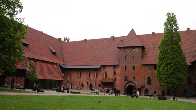 Poland Malbork Castle tourism coutyard. Medieval castle of the Teutonic Order. 13th century, Largest castle in the world by land area, 52 acres. Historical buildings. Educational displays.