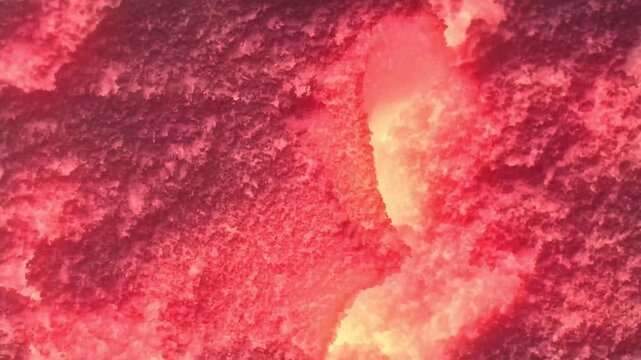 Molten Lava Flowing Through Cracked Ground: Abstract Volcanic Disaster Background. High quality 4k footage