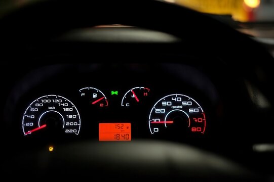 Car dashboard warning lights at night